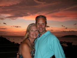 man and woman hugging at sunset